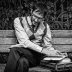 man on bench reading books every husband should read